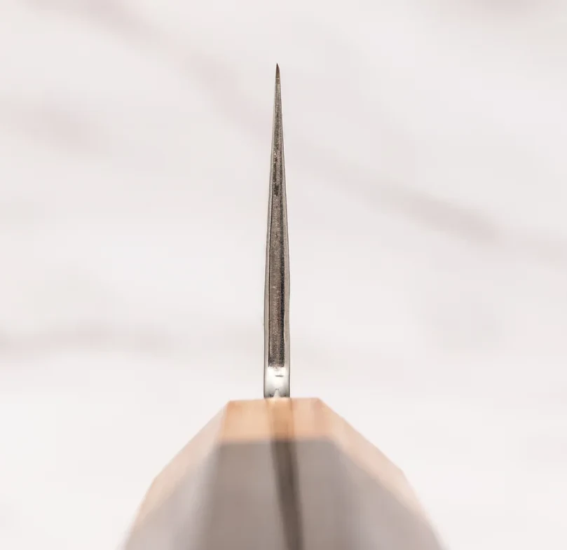 Close-up of the gyuto's hand-honed tip and thin blade profile